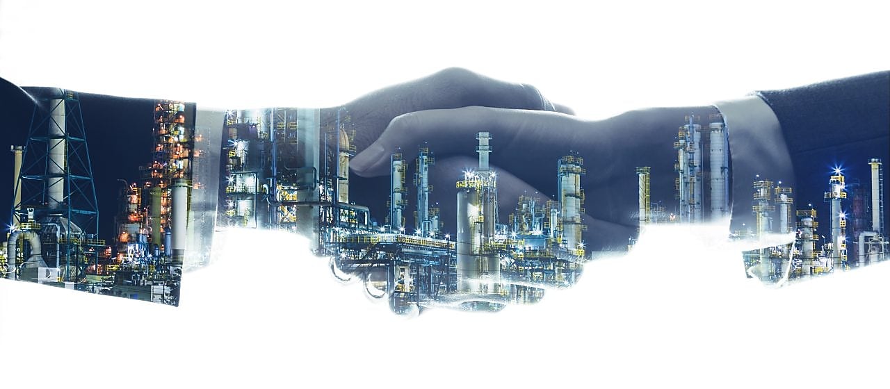 The suite sleve of two business men shaking hands shaking against a white background